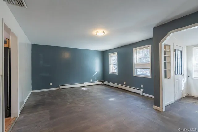 an empty room with windows and closet