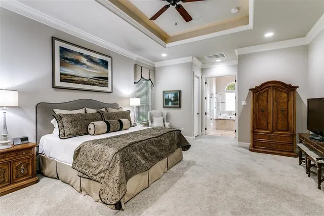 a spacious bedroom with a bed a couch and dresser