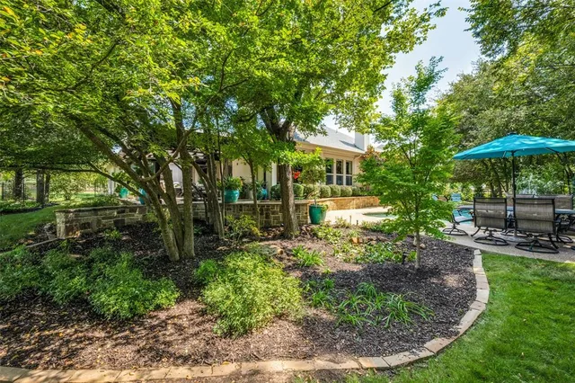 a view of a house with backyard and sitting area
