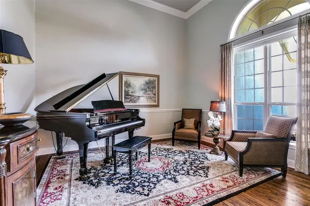 a living room with a couch a rug and wooden floor