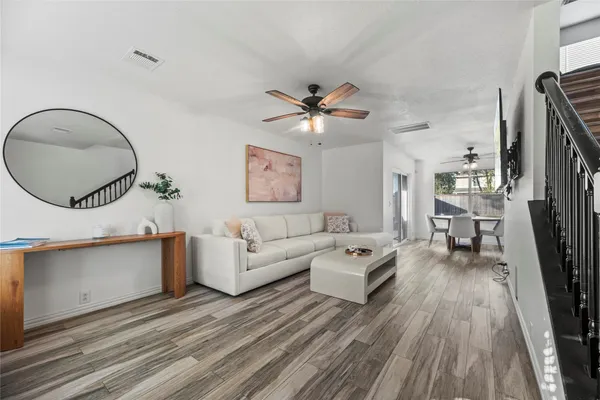 a living room with furniture and a large mirror
