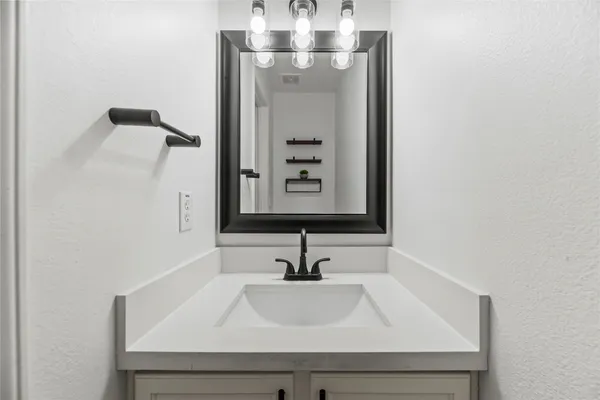 a bathroom with a sink and mirror