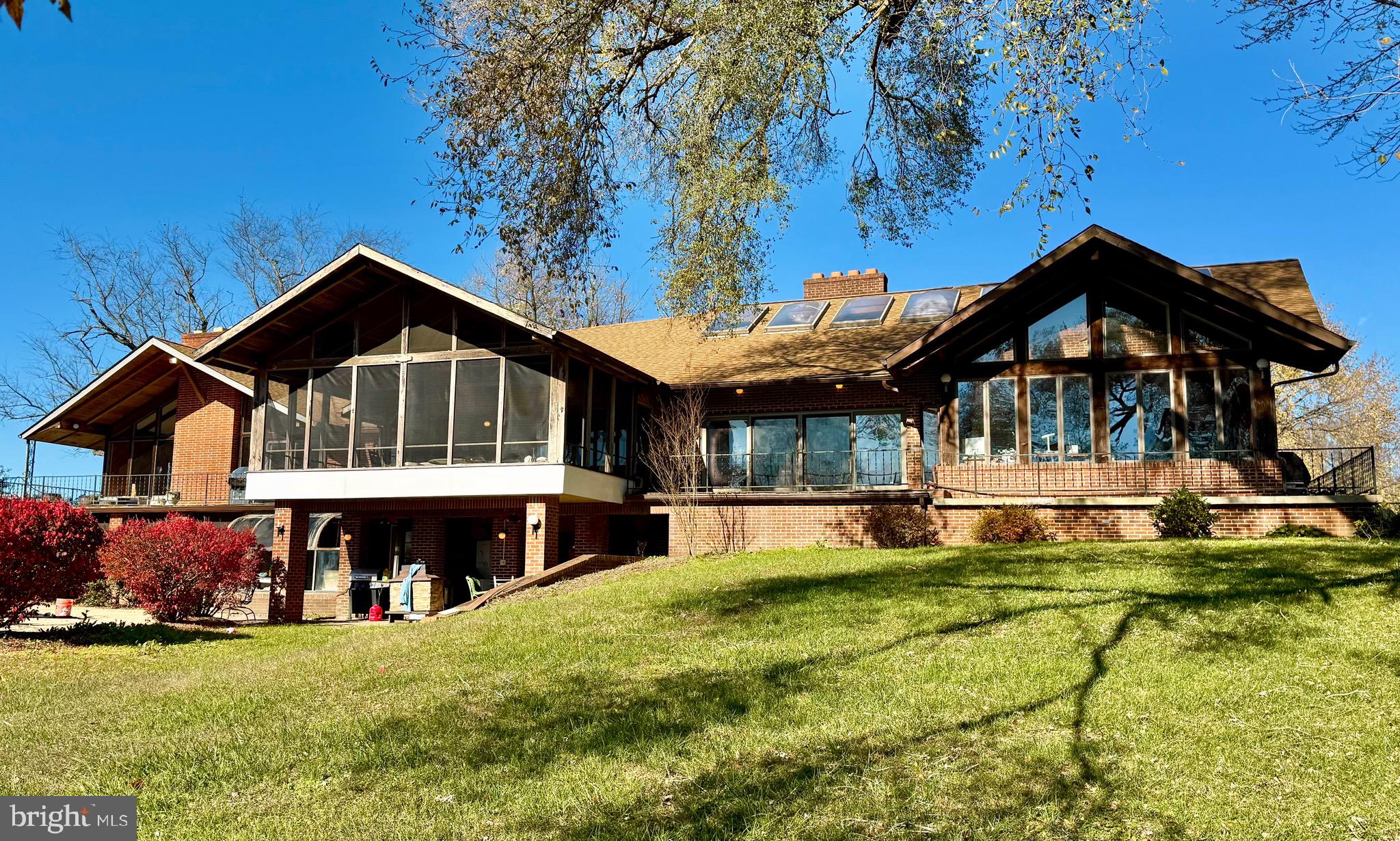 a view of a house with a big yard and sitting area