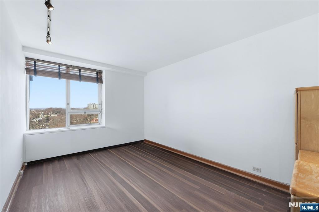 2 Horizon Road, Unit 1010 Fort Lee, NJ 07024 - Photo 15 of 42 a view of an empty room with wooden floor and a window