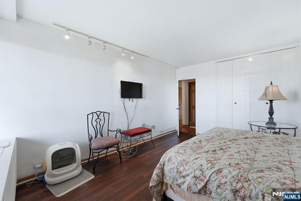 2 Horizon Road, Unit 1010 Fort Lee, NJ 07024 - Photo 17 of 42 a bedroom with a bed and a chair