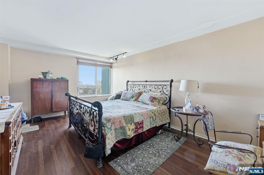 2 Horizon Road, Unit 1010 Fort Lee, NJ 07024 - Photo 18 of 42 a bedroom with a bed and wooden floor