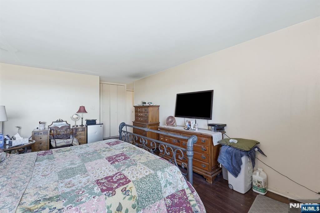 2 Horizon Road, Unit 1010 Fort Lee, NJ 07024 - Photo 20 of 42 a bedroom with a bed and a flat screen tv