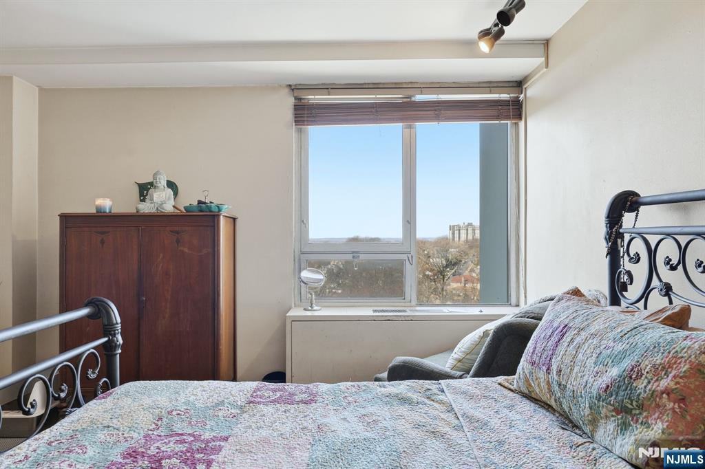 2 Horizon Road, Unit 1010 Fort Lee, NJ 07024 - Photo 21 of 42 a bedroom with a bed and a window