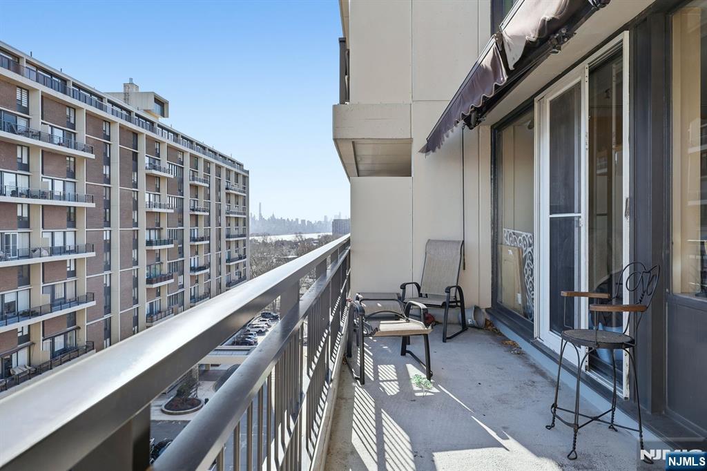 2 Horizon Road, Unit 1010 Fort Lee, NJ 07024 - Photo 27 of 42 a balcony with wooden floor and furniture