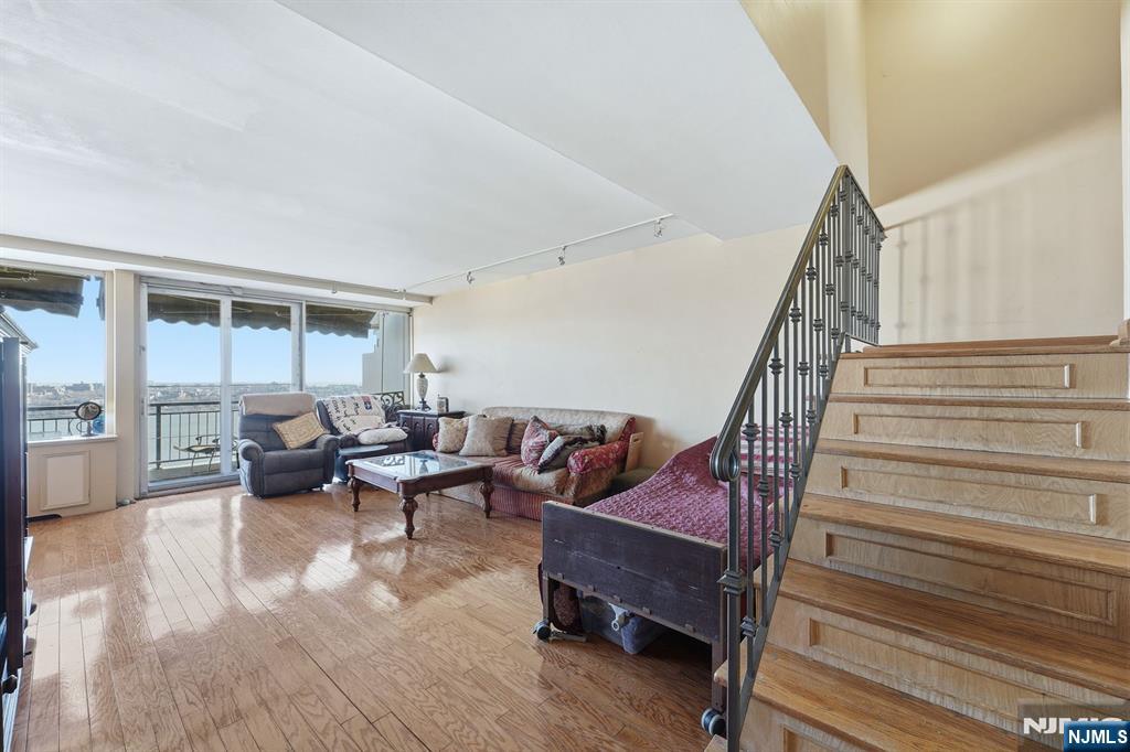 2 Horizon Road, Unit 1010 Fort Lee, NJ 07024 - Photo 4 of 42 a living room with furniture and a wooden floor