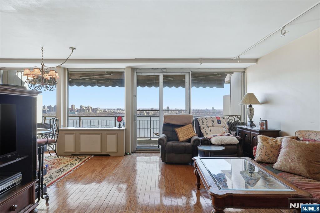 2 Horizon Road, Unit 1010 Fort Lee, NJ 07024 - Photo 5 of 42 a living room with furniture and a fireplace