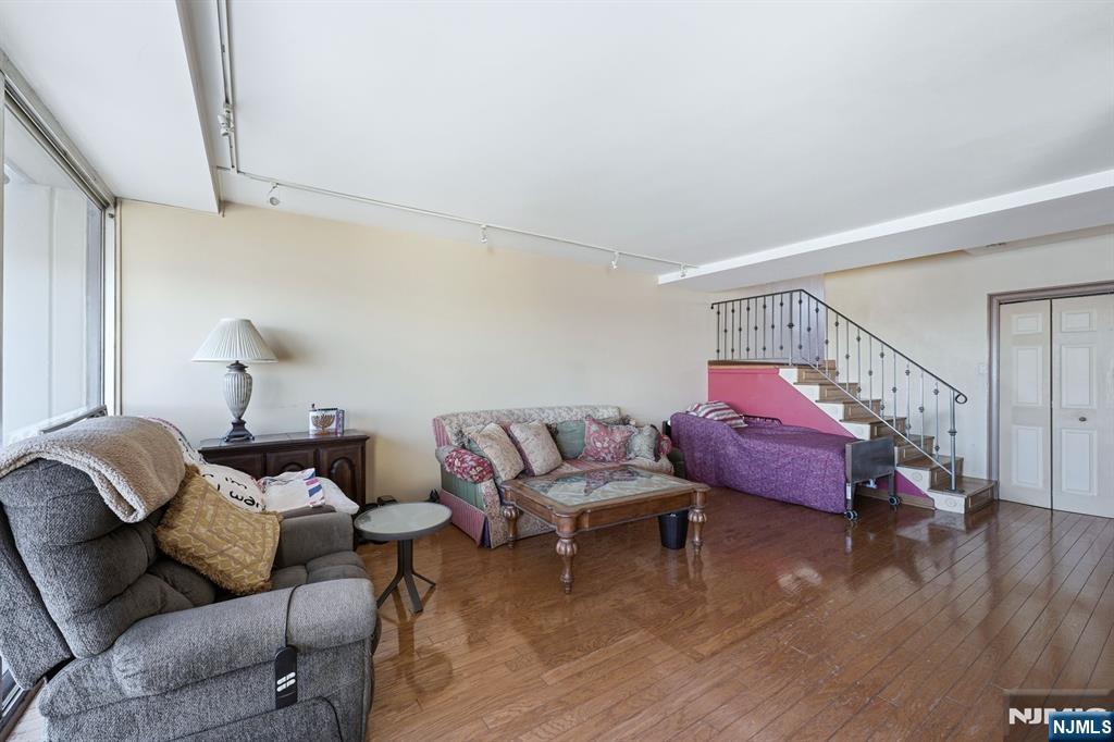 2 Horizon Road, Unit 1010 Fort Lee, NJ 07024 - Photo 7 of 42 a living room with furniture and a wooden floor