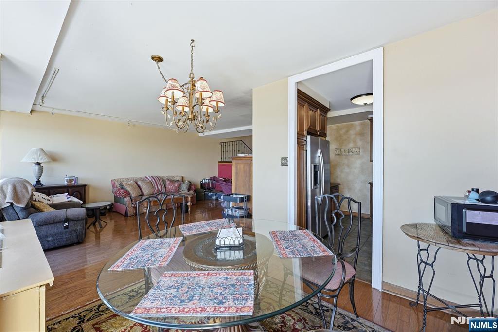 2 Horizon Road, Unit 1010 Fort Lee, NJ 07024 - Photo 9 of 42 a living room with furniture and a chandelier