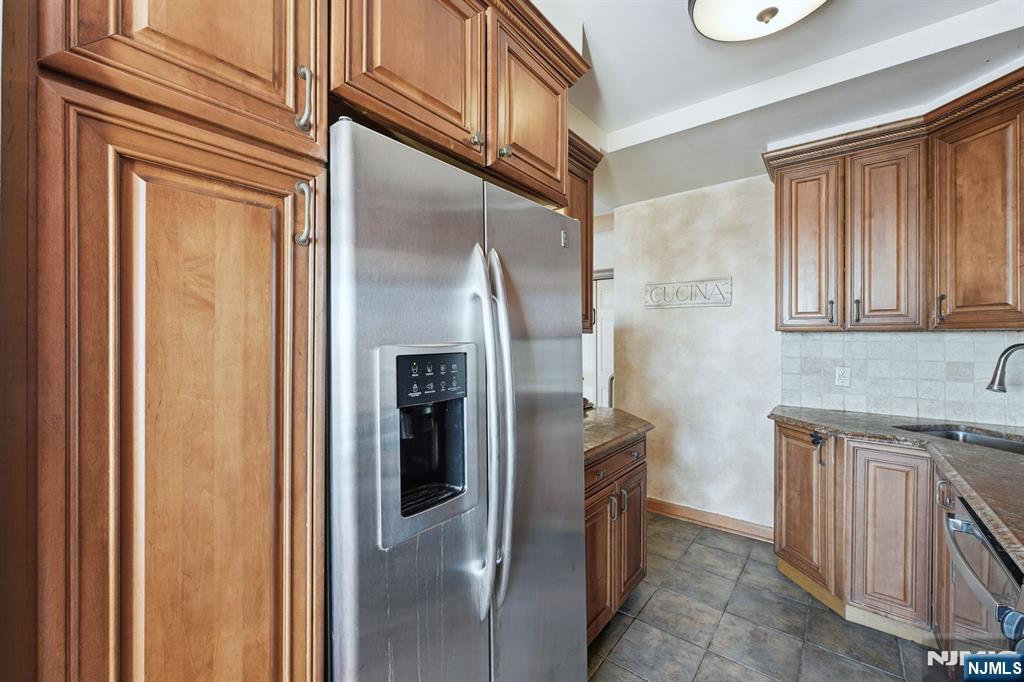 2 Horizon Road, Unit 1010 Fort Lee, NJ 07024 - Photo 10 of 42 a kitchen with stainless steel appliances granite countertop a refrigerator and a sink
