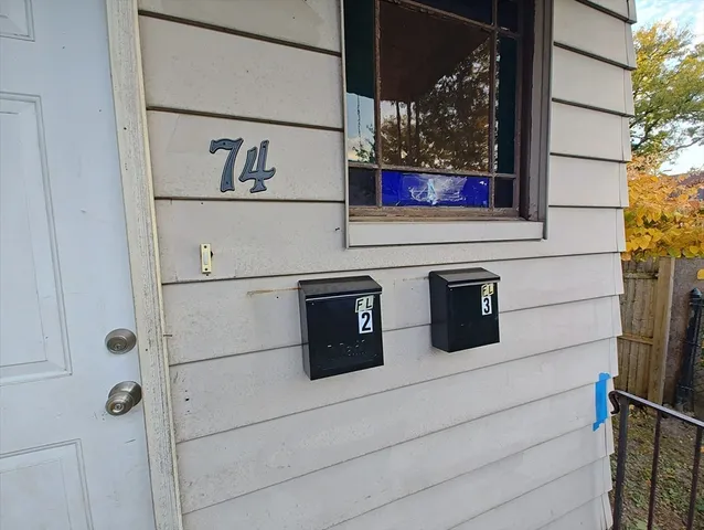 a kitchen with granite countertop white cabinets and wooden floor