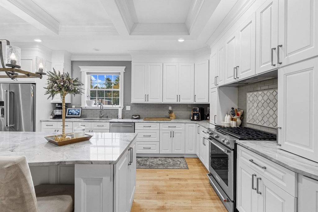 35 High Street Freetown, MA 02702 - Photo 25 of 40 a kitchen with granite countertop stainless steel appliances and wooden cabinets