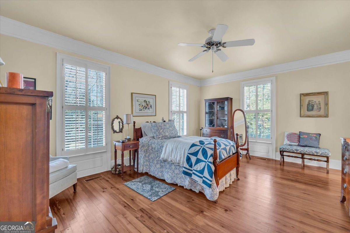 661 East Walton Street Madison, GA 30650 - Photo 17 of 35 a bedroom with a bed and wooden floor