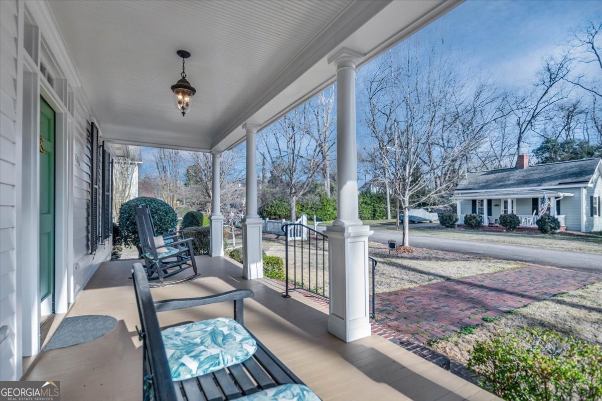 661 East Walton Street Madison, GA 30650 - Photo 3 of 35 a view of a porch with furniture and garden
