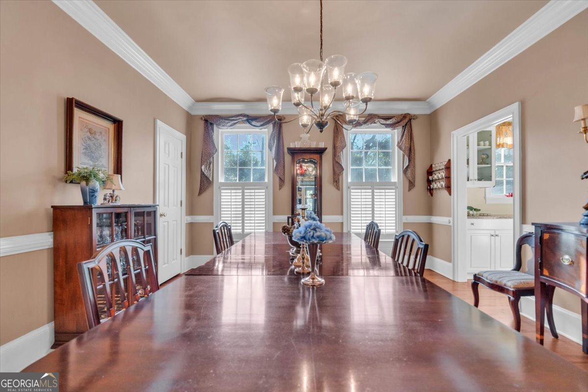 661 East Walton Street Madison, GA 30650 - Photo 8 of 35 a view of a dining room with furniture wooden floor and chandelier