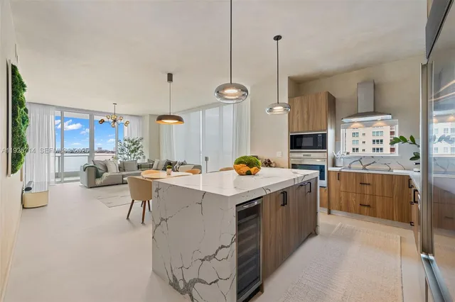 a kitchen that has a lot of cabinets and stainless steel appliances