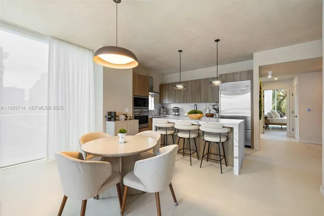 a large kitchen with a table and chairs