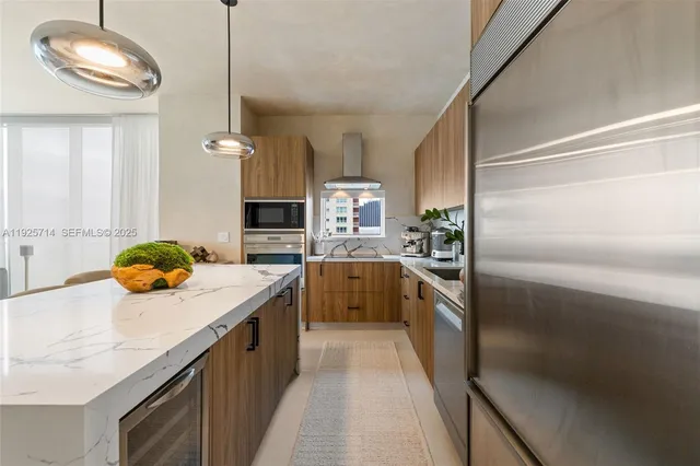 a kitchen with stainless steel appliances granite countertop a sink a stove and a refrigerator