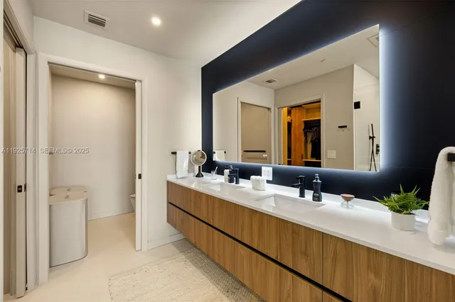 a bathroom with a double vanity sink and mirror