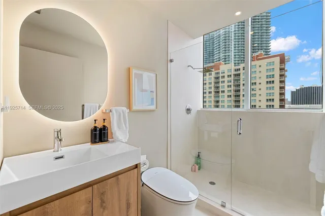 a bedroom with furniture and a large window