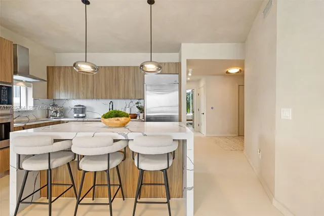 a kitchen with a dining table chairs and white cabinets