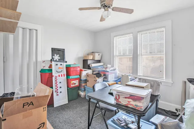 a living room with furniture a flat screen tv and a window