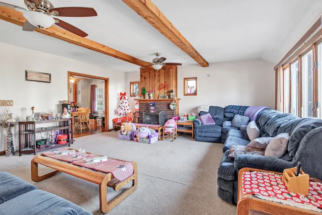 a living room with furniture a rug and a window