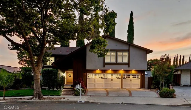 a view of a house with a tree