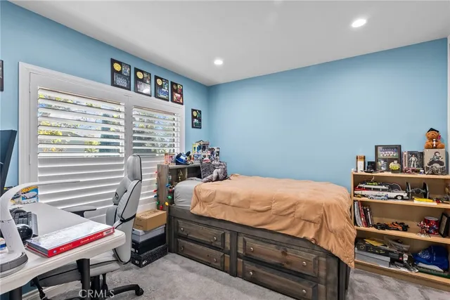 a bedroom with a bed and a bookshelf