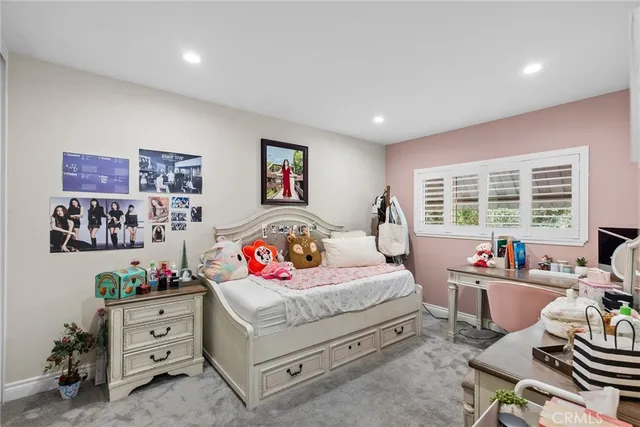 a bedroom with a bed dresser and a window