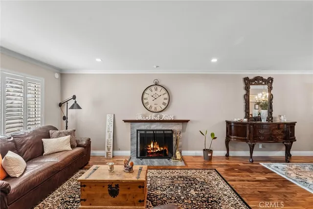 a living room with furniture a clock and a fireplace