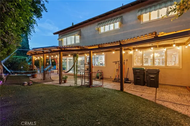 a view of a house with backyard porch and sitting area