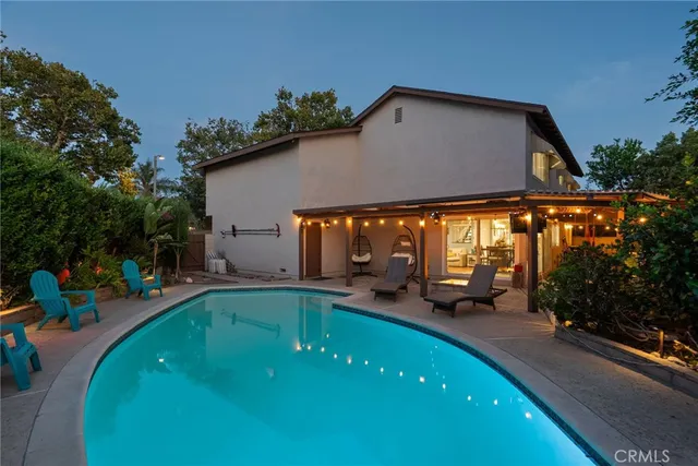 an outdoor space with pool and furniture