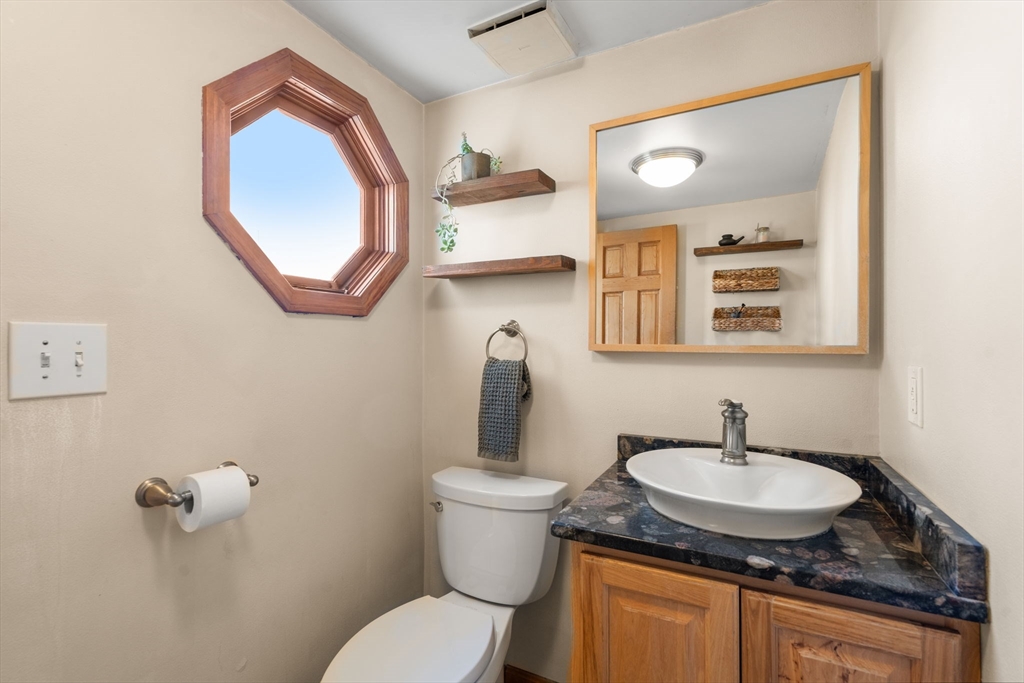 2 Brooks Street Maynard, MA 01754 - Photo 23 of 42 a bathroom with a granite countertop sink and a mirror
