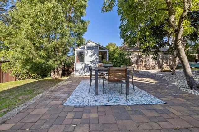 a view of a house with wooden fence