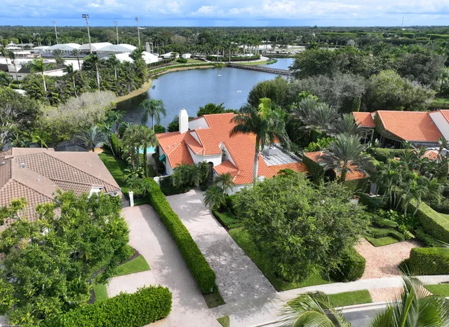 an aerial view of residential houses with outdoor space and street view