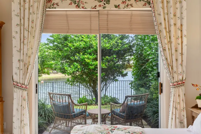 a couple of palm trees sitting in a yard with swimming pool