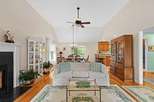 a living room with furniture a chandelier and a flat screen tv