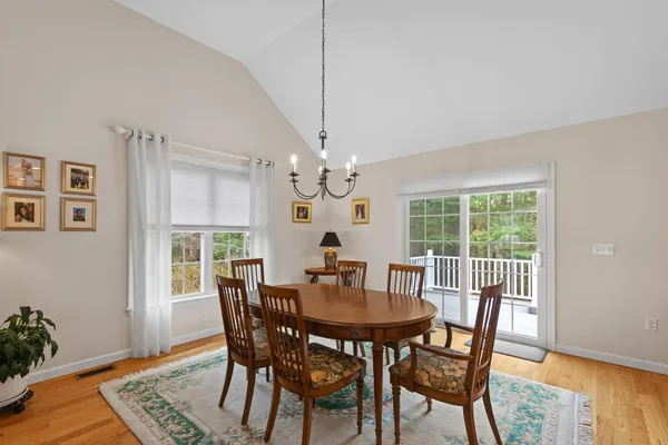 a dining room with furniture a rug and wooden floor