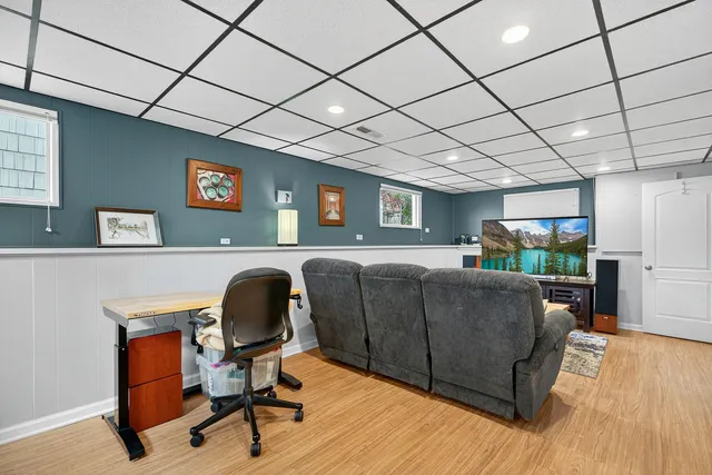 a livingroom with workspace and a couch