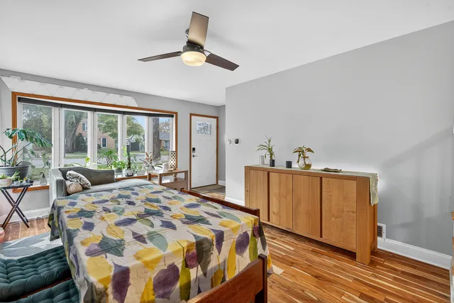 a bed sitting in a bedroom next to a window