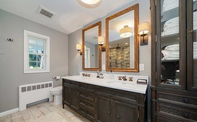 453 West Saddle River Road Upper Saddle River, NJ 07458 - Photo 12 of 28 a bathroom with a double vanity sink a mirror and a bathtub next to a window