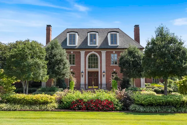 a front view of a house with garden