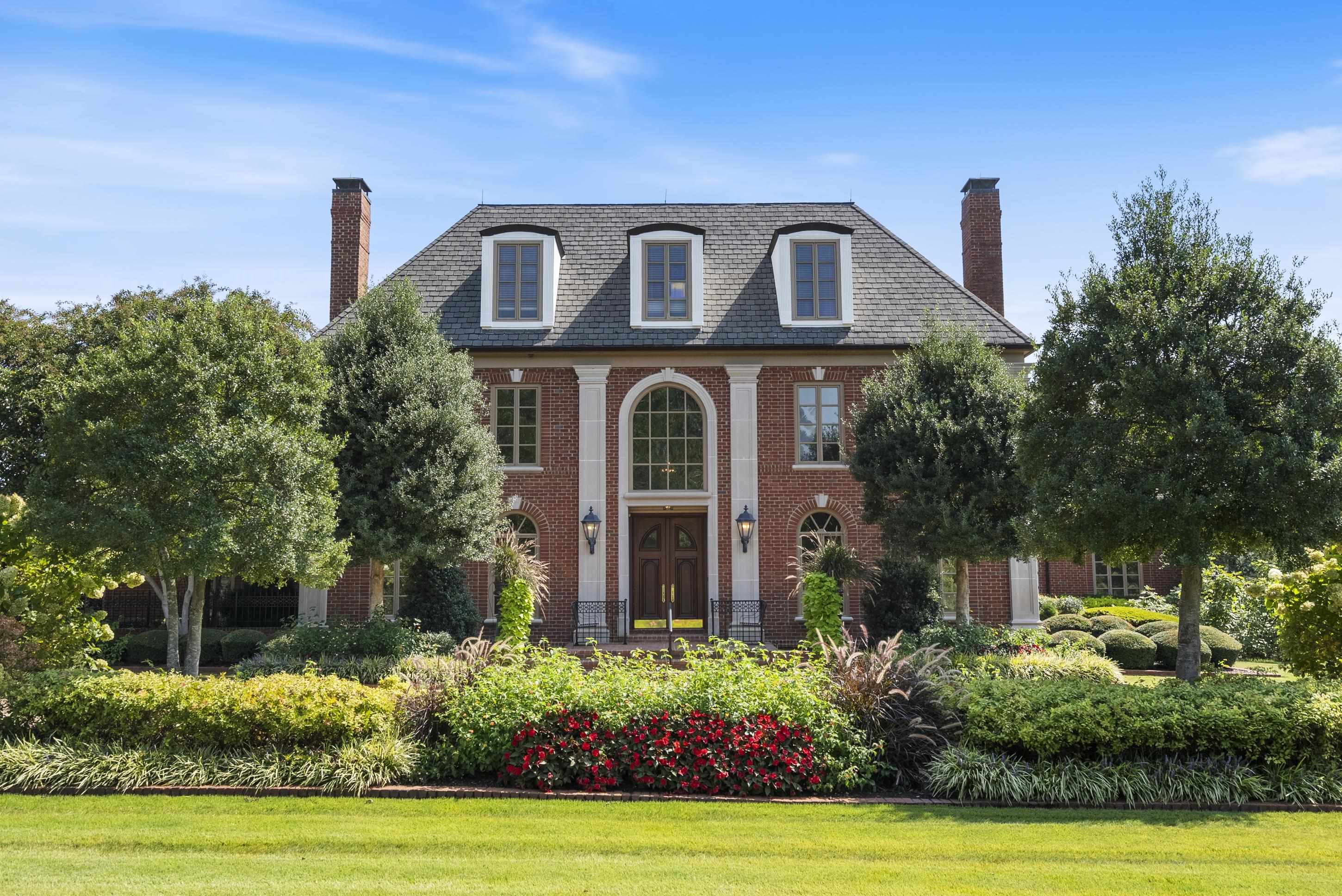 a front view of a house with garden