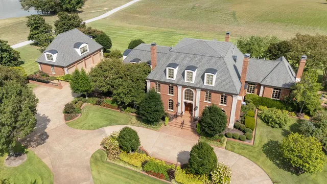 an aerial view of a house with a yard and potted plants