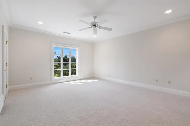a view of room with stairs and a ceiling fan